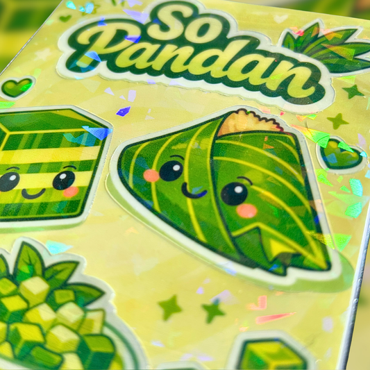 Close up image of sticker sheet with cartoon pandan-themed designs held by a hand against a decorative background.