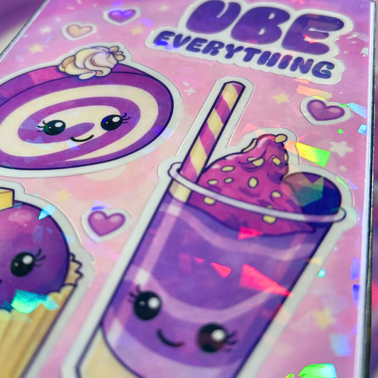 Close up image of sticker sheet with ube themed illustrations held by a hand against a colorful, abstract background.