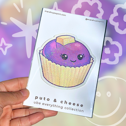 Card with a purple ube puto and cheese die cut decal held by a hand against a colorful background