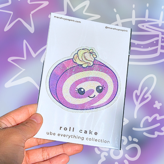 Card with a ube roll cake design die cut decal held by a hand against a colorful background