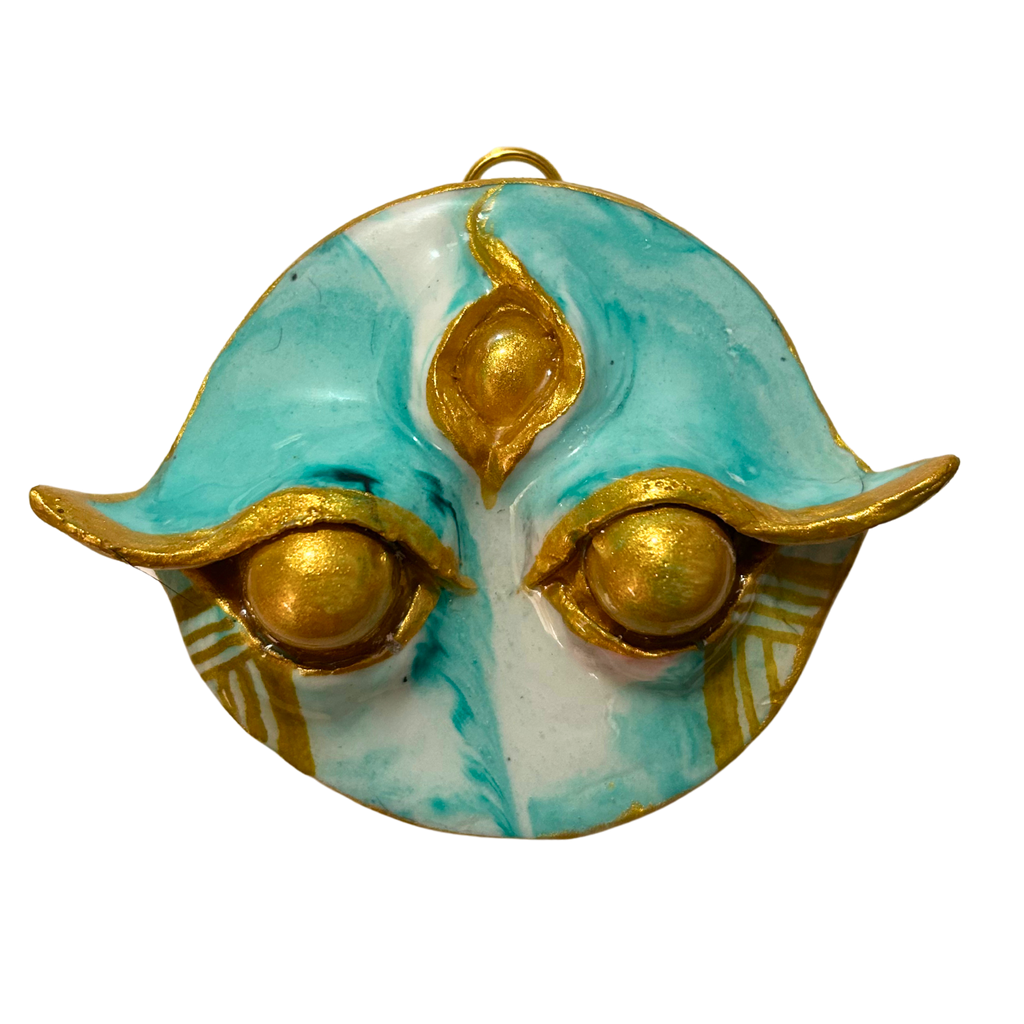 Batok Spirit handmade Filipino guardian charm with gold batok tattoo symbols on white background